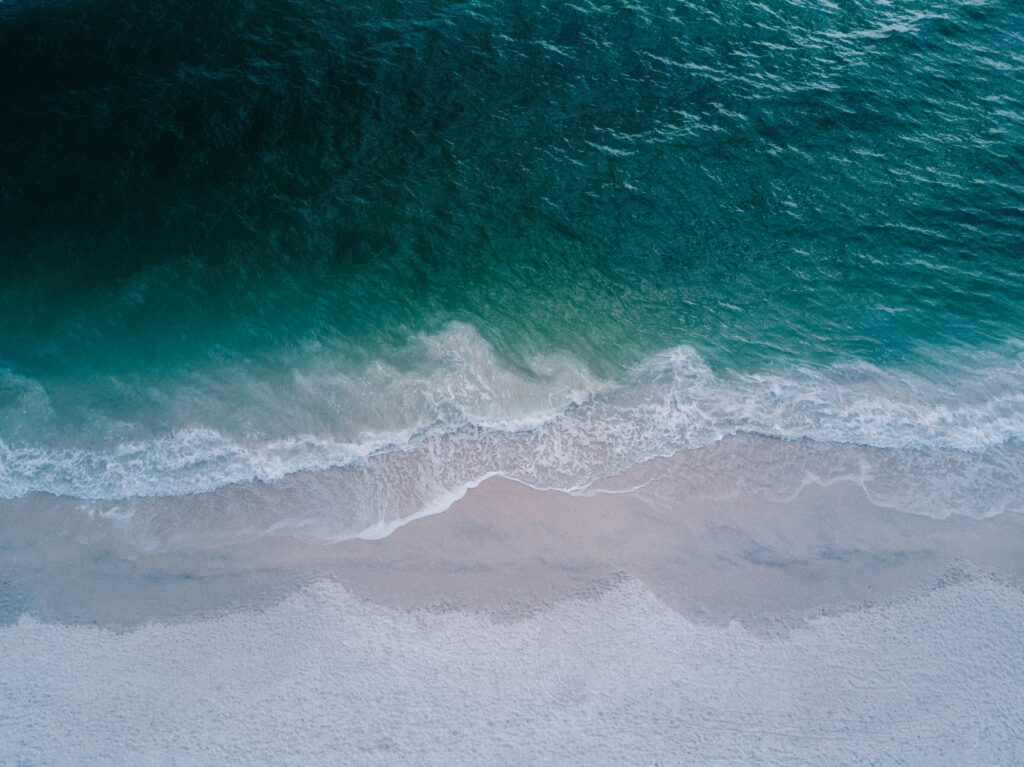 Ocean waves crashing over sand on a beach