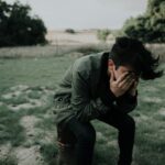 Man sitting with his head in his hands