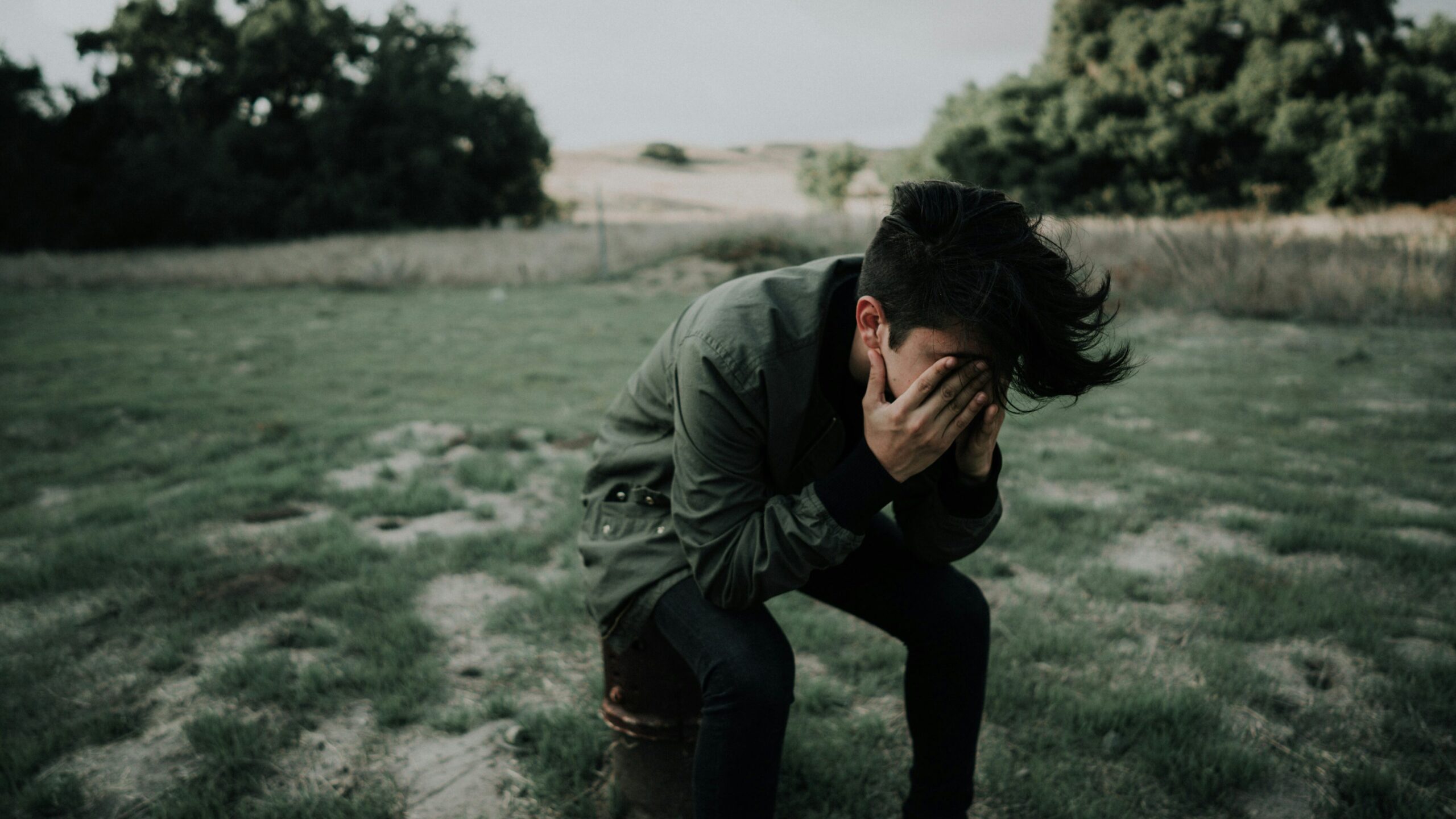 Man sitting with his head in his hands