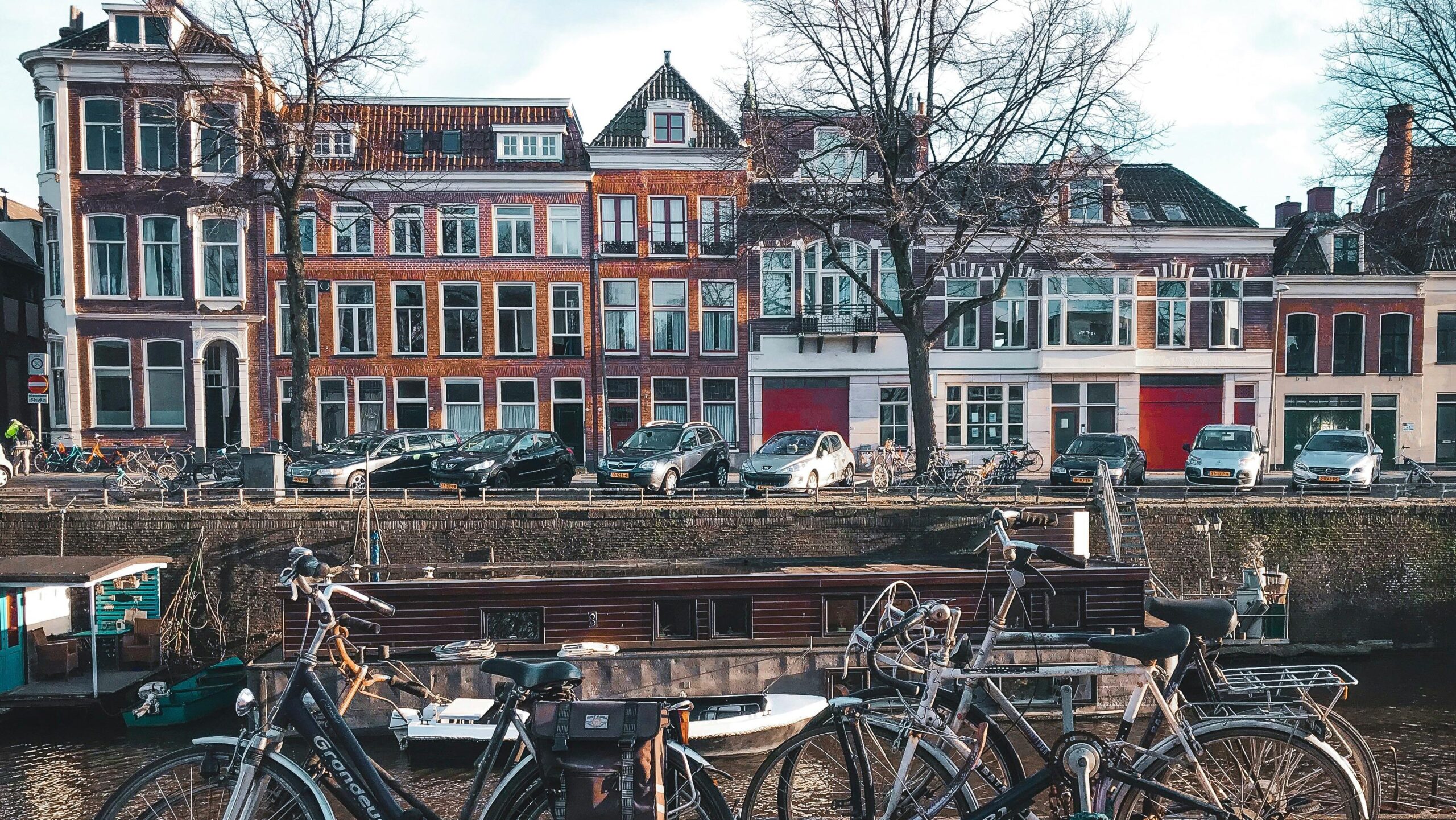 Bicycles parked by a river in a Dutch town