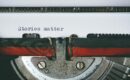 A typewriter showing the words "Stories matter" typed onto a white page