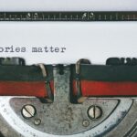 A typewriter showing the words "Stories matter" typed onto a white page