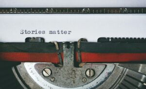 A typewriter with the words "stories matter" on the page