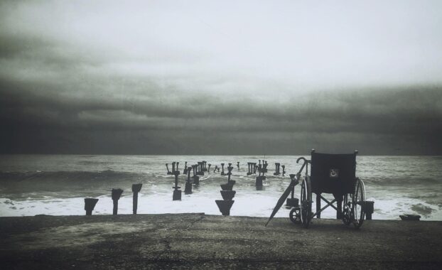 An abandoned wheelchair by the sea. Image by StockSnap from Pixabay