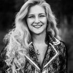 Black and white photo of literary agent Lucienne Diver, a smiling white woman with long blond hair