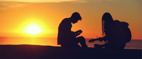 Two musicians playing guitars during a sunset Image by Mike Giles from StockSnap