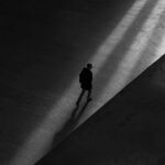 A man walking in shadows Photo by Bob Price