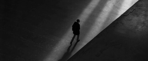 A man walking in shadows Photo by Bob Price