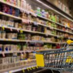 Empty grocery aisle with a small shopping cart. Image by Tumisu from Pixabay