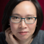 Photo of Chinese-American author Malinda Lo, with dark hair and glasses.