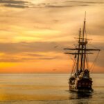 Photo by Pixabay: https://www.pexels.com/photo/a-pirate-ship-sailing-on-sea-during-golden-hour-37730/